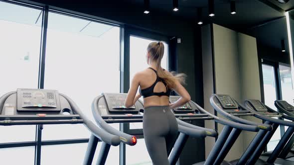 Fit Woman Running on Treadmill