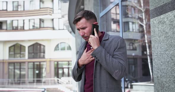 Man Talking on the Phone Near Office Centre and Starts to Cough with Dyspnea