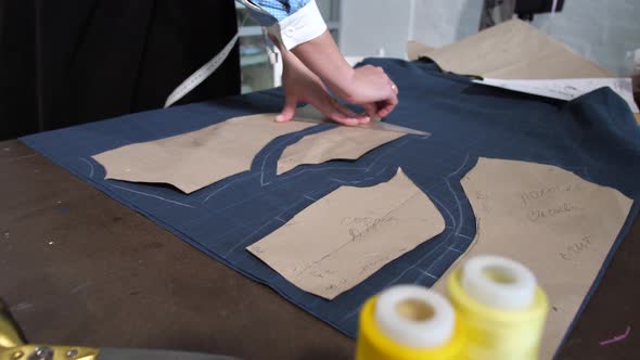 Hands of Seamstress Making Patterns of Dress