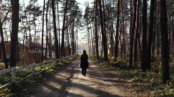 A woman walks in the woods