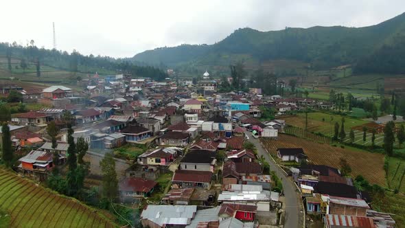Aerial view of traditional village surrounded by hills on Java island, Indonesia