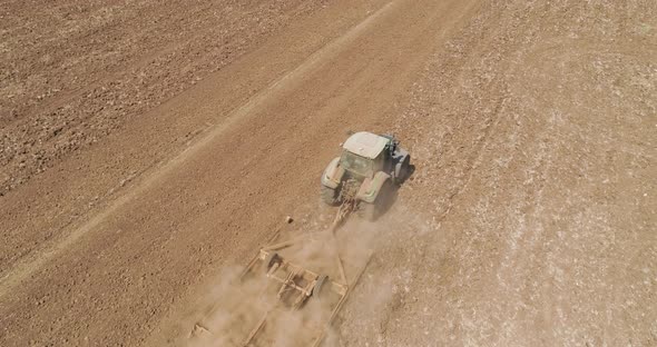 Aerial view of a tractor ploughing an empty field, Kibbutz saar, Israel.