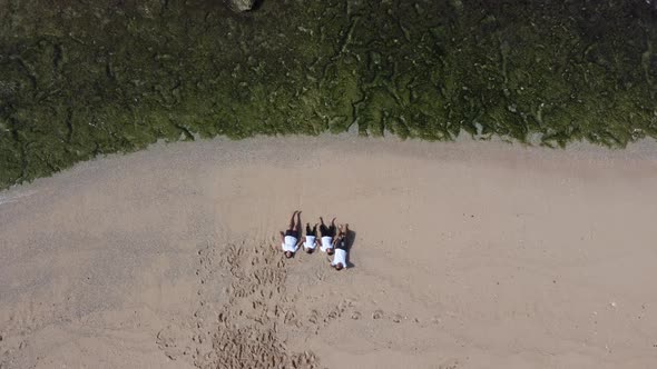 Top view of asian family relaxing on the beach