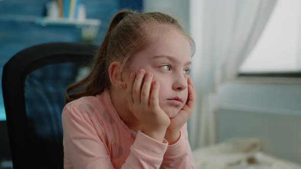 Close Up of Tired Child Listening to Remote Online Lesson