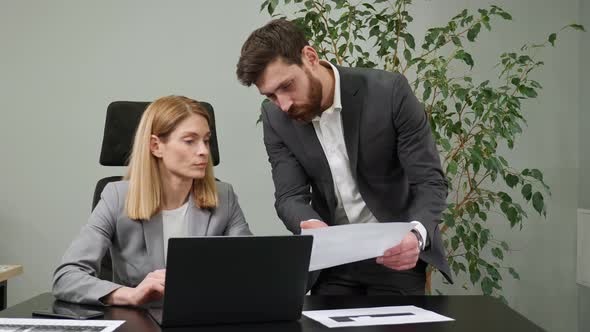 Pretty Serious Female Leader and Male Businessman Discuss Work Solve Problems