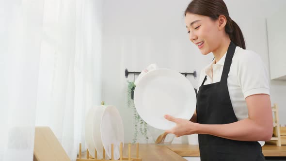 Asian active cleaning service woman worker cleaning in kitchen at home for housekeeping housework.