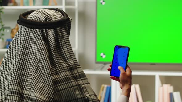 Middle Eastern Man Using Phone with Chroma Key Closeup alt