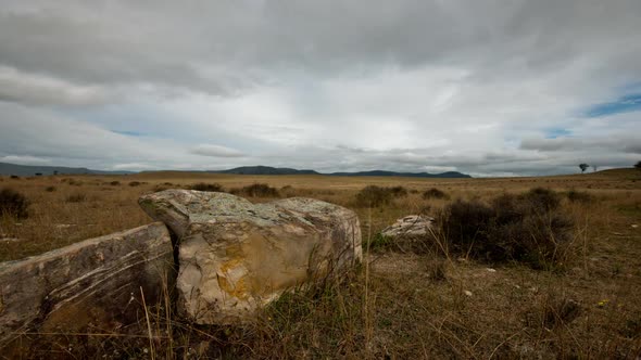 Cloudscape Time-lapse with large boulders in the foreground