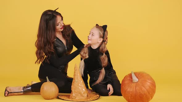 Mother and Daughter with Wearing Halloween Costumes Have in Orange Studio