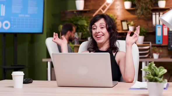 Office Worker Reads Some Good News on the Laptop