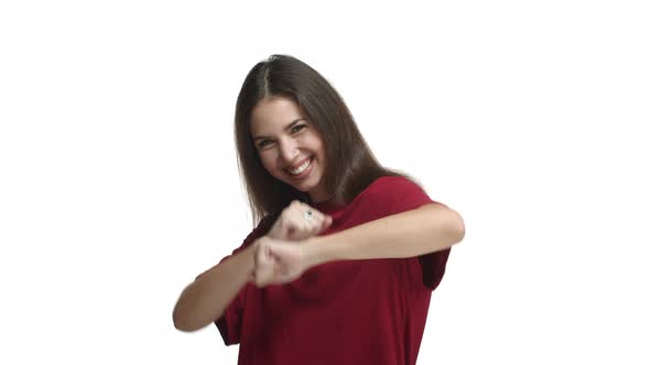 Attractive Happy Woman in Red Tshirt Celebrating Dancing From Joy Standing Over White Background