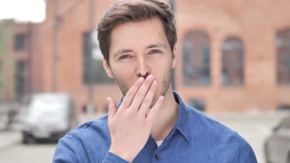 Flying Kiss By Young Man Standing Outdoor