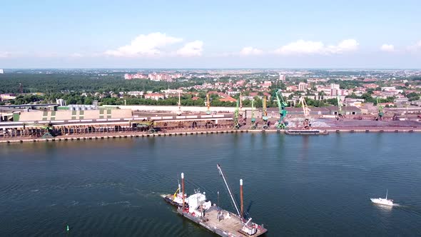 Industrial part of Klaipeda harbor and city skyline in aerial view