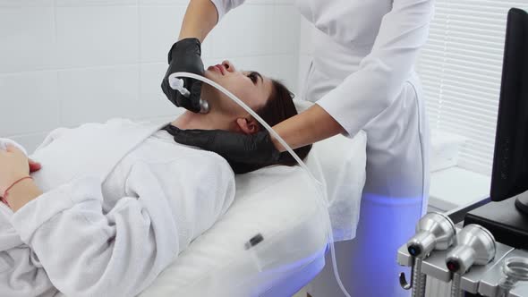 Face Massage  Young Woman Having an Electric Massage Procedure on Her Neck