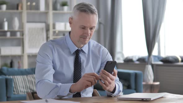 Gray Hair Businessman Using Smartphone