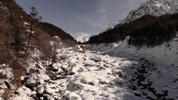 Winter Forest and Snowcapped River with a High Iron Content in Drifts of White Snow High in the