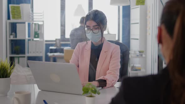 Portrait of Business Woman with Protection Face Mask Working on Laptop Computer