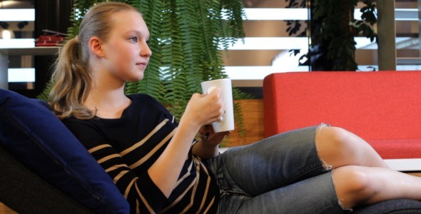Female Student Relaxing in Campus Rest Room