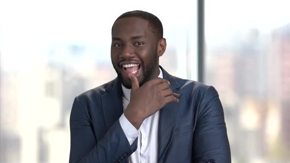 Playful Sexy Businessman on Blurred Background.