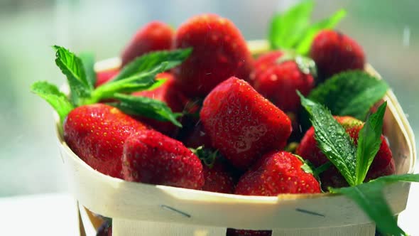 Punnet of Fresh Strawberries in a Spray of Water