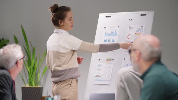 Young Woman Giving Presentation at Business Meeting