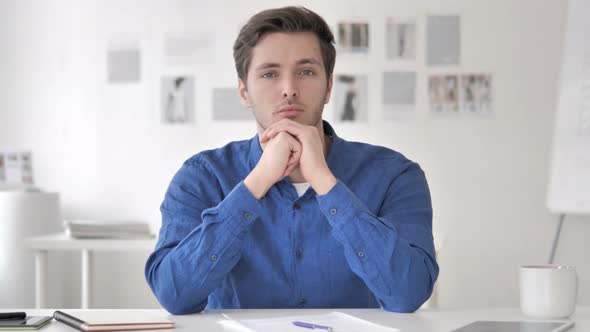 Confident Casual Adult Man Sitting at Workplace