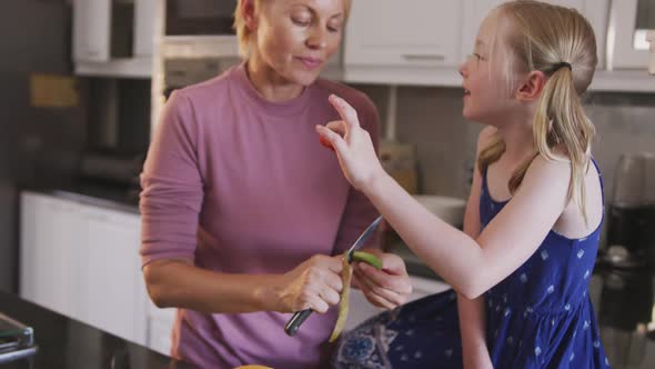 Front view of Caucasian woman with her daughter in the kitchen