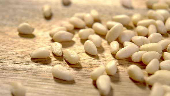 Pine nuts. Raw peeled cedar seeds on wooden rustic surface. Macro