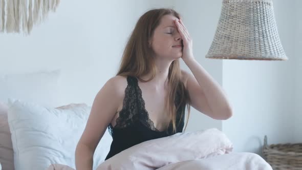 Middle Shot of Happy Redhead Girl Stretching in Bed in the Morning. Smiling Beautiful Caucasian Girl