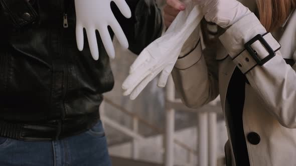 Couple Puts on Medical Gloves in the City