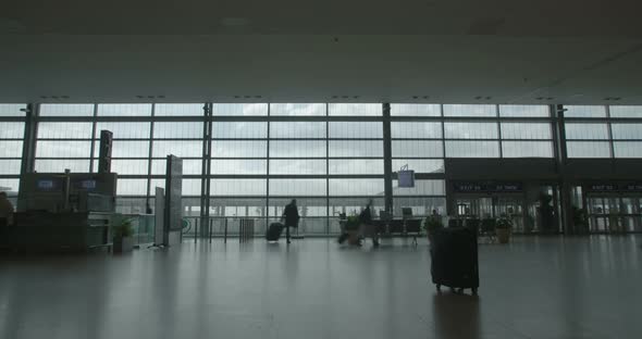 silhouette of People in airport terminal walking with luggage