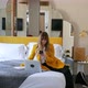 Woman using smart phone and laptop in hotel room, Florence, Tuscany, Italy - VideoHive Item for Sale