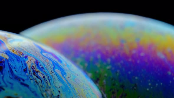 Macro Shot of a Soap Bubble Creates a Colorful and Black Background