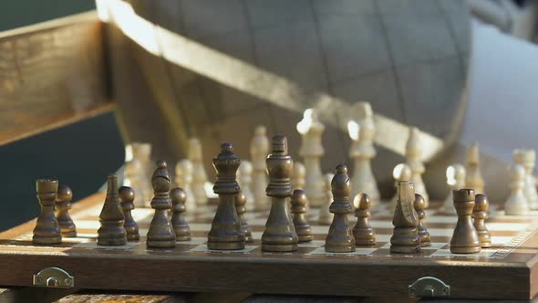 Senior Man Playing Chess on Park Bench, Moving Vintage Figures on Board, Hobby