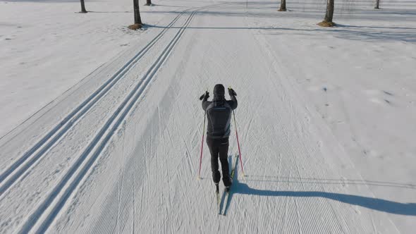 Cross Country Skier Skiing Along Snowy Path