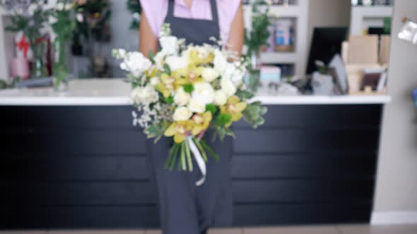 Florist Woman Comes with Beautiful Bouquet of Roses and Lilies in Her Hands.