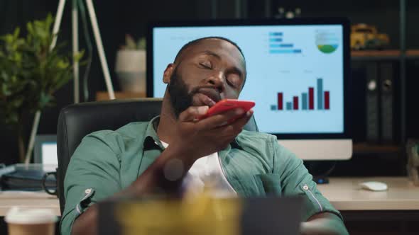 Closeup Smiling Afro Business Man Chatting By Mobile Phone in Hipster Office