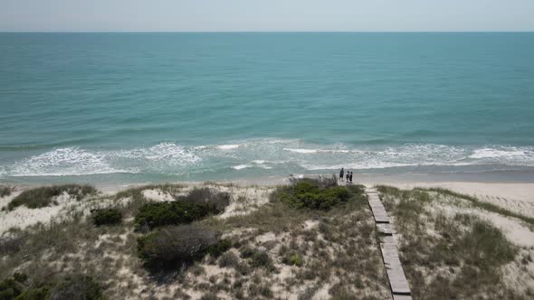 bald head island board walks over sand dunes toward sea Aerial