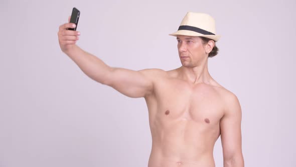 Happy Muscular Tourist Man Smiling While Taking Selfie Shirtless