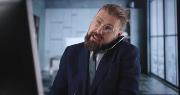 Man Using Pc and Mobile at Office