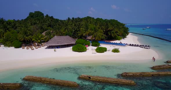 Wide angle drone abstract shot of a white paradise beach and aqua blue ocean background in colorful 