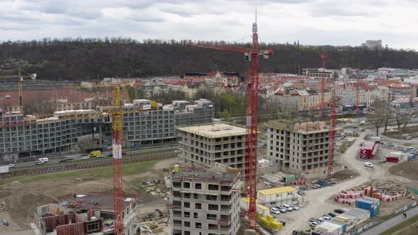 Workers on rooftop of unfinished building at construction site, Prague.