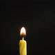 Single Big Yellow Candle Flame Lights and Extinguish Isolated on a Black Background Slow Motion - VideoHive Item for Sale