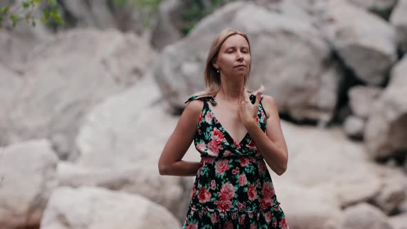 Adult Woman Does Meditative Exercises on Nature