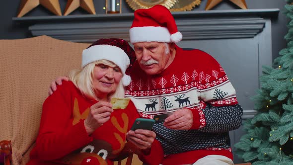 Senior Family Grandmother Grandmother Using Credit Bank Card and Smartphone Shopping Christmas Gifts