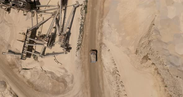 Stone sorting station in a large Quarry, with rocks transported on conveyor belts, Aerial view.