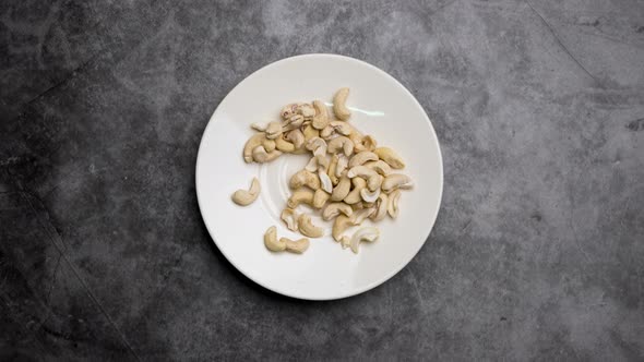 Top view Stop motion animation Cashew nuts in a white bowl.
