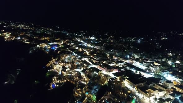 City of Santorini by night on the island of Santorini in Greece from the sky