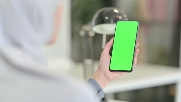 Rear View of Arab Woman Looking at Smartphone with Chroma Key Screen