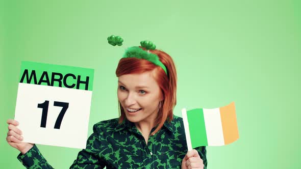 Woman with Irish flag celebrating Saint Patrick's Day